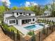 A view of the backyard with a pool, patio, hot tub, and manicured landscaping at 861 Wimbleton Dr, Raleigh, NC 27609