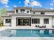 A luxurious backyard featuring a large pool, patio seating, and a modern two-story home at 861 Wimbleton Dr, Raleigh, NC 27609