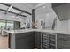 Contemporary bar area featuring counter seating, beverage cooler, and staircase view at 861 Wimbleton Dr, Raleigh, NC 27609
