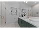 Bright bathroom with modern design, green cabinets, white countertops, and glass enclosed shower at 861 Wimbleton Dr, Raleigh, NC 27609