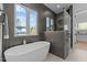 Luxurious bathroom featuring a soaking tub with large window and adjacent walk-in shower at 861 Wimbleton Dr, Raleigh, NC 27609
