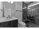Modern bathroom featuring a sleek vanity and glass-enclosed shower with stylish dark marbled tile at 861 Wimbleton Dr, Raleigh, NC 27609