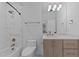 Bright bathroom with marble-style tile, modern vanity, and bathtub-shower combination at 861 Wimbleton Dr, Raleigh, NC 27609
