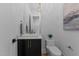 Stylish powder room featuring modern vanity with a vessel sink and elegant fixtures, plus decorative lighting at 861 Wimbleton Dr, Raleigh, NC 27609