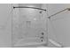 Bathroom featuring a shower-tub, decorative marble-style tile, and modern fixtures at 861 Wimbleton Dr, Raleigh, NC 27609
