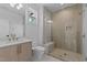 Modern bathroom with glass shower door, bench, and sleek vanity with contemporary fixtures at 861 Wimbleton Dr, Raleigh, NC 27609