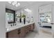 Bright bathroom featuring a double vanity, contemporary fixtures, and a peek into an airy bedroom at 861 Wimbleton Dr, Raleigh, NC 27609