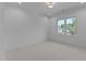Bright bedroom with neutral carpet, a large window with neighborhood views, and recessed lighting at 861 Wimbleton Dr, Raleigh, NC 27609