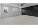 Spacious bedroom featuring three windows for ample natural light, ceiling fan, and a feature wall at 861 Wimbleton Dr, Raleigh, NC 27609