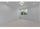 Bright bedroom featuring neutral carpet, a modern light fixture, and a window with green outdoor views at 861 Wimbleton Dr, Raleigh, NC 27609
