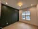 Stylish bedroom featuring a decorative wall panel and view of the backyard pool at 861 Wimbleton Dr, Raleigh, NC 27609