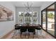 Elegant dining room with a view of the pool area through large windows and sliding doors at 861 Wimbleton Dr, Raleigh, NC 27609