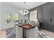 Stylish dining room with modern chandelier, gray accent wall, and sleek furnishings at 861 Wimbleton Dr, Raleigh, NC 27609