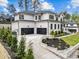 An exterior view showing a modern two-story home with a driveway and a three-car garage at 861 Wimbleton Dr, Raleigh, NC 27609