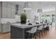 Bright, modern kitchen with an oversized island, stainless steel appliances, pendant lighting, and white counter seating at 861 Wimbleton Dr, Raleigh, NC 27609