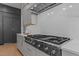 Close-up of a high-end stainless steel range with custom hood and backsplash at 861 Wimbleton Dr, Raleigh, NC 27609