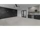 Open living area with a sleek feature wall, glass doors, and a bar area with a beverage cooler at 861 Wimbleton Dr, Raleigh, NC 27609