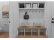 Organized mudroom with built-in bench, hooks, shelves, and decorative accents at 861 Wimbleton Dr, Raleigh, NC 27609
