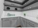 Well-organized pantry featuring gray cabinets, white countertop, and decorative shelving with accent lighting at 861 Wimbleton Dr, Raleigh, NC 27609
