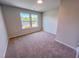 Cozy bedroom with carpet flooring and a pair of bright windows at 457 Duncan Creek Rd # 141, Lillington, NC 27546