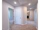 Hallway featuring neutral-toned carpet and doors leading to various rooms at 457 Duncan Creek Rd # 141, Lillington, NC 27546