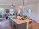 Well-equipped kitchen island features modern fixtures, sleek countertops, and comfortable bar seating at 457 Duncan Creek Rd # 141, Lillington, NC 27546