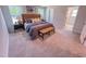Spacious main bedroom with decorative bench, bedside tables, and natural light at 457 Duncan Creek Rd # 141, Lillington, NC 27546