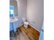 This powder room features wood-look flooring, pedestal sink, and modern fixtures at 457 Duncan Creek Rd # 141, Lillington, NC 27546