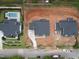 Aerial view of homes with modern landscaping, a pool, and new construction development nearby at 865 Wimbleton Dr, Raleigh, NC 27609