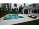 A modern backyard pool and patio area with in-pool seating, dining, and lounge area with backyard views at 865 Wimbleton Dr, Raleigh, NC 27609