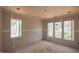 Unfinished bedroom with large windows providing ample natural light at 865 Wimbleton Dr, Raleigh, NC 27609