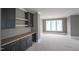 Bonus room showcasing black cabinets, wood shelving, and a large window for natural light at 865 Wimbleton Dr, Raleigh, NC 27609