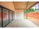Stunning covered patio with stone floors and a view of the expansive backyard and landscaping at 865 Wimbleton Dr, Raleigh, NC 27609