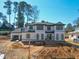 New construction two-story home showcasing brick work, covered entry, and visible framing details at 865 Wimbleton Dr, Raleigh, NC 27609