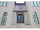 The beautiful custom front door is framed by arched windows and elegant grey brick at 865 Wimbleton Dr, Raleigh, NC 27609