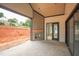 Covered porch featuring an outdoor fireplace for cozy evenings with beautiful stone flooring at 865 Wimbleton Dr, Raleigh, NC 27609