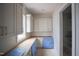 This walk-in pantry features custom cabinets and a large window for abundant natural light at 865 Wimbleton Dr, Raleigh, NC 27609