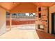 Unfinished covered patio with a modern fireplace, offering a serene view of the yard at 865 Wimbleton Dr, Raleigh, NC 27609