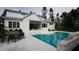 A modern white two-story home and its outdoor pool area for leisure and entertaining at 865 Wimbleton Dr, Raleigh, NC 27609