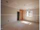 An unfinished room featuring a framed doorway and a window at 865 Wimbleton Dr, Raleigh, NC 27609