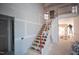 Unfinished staircase with temporary railing, leading to the second floor, view of a large unfinished room at 865 Wimbleton Dr, Raleigh, NC 27609
