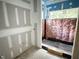 Partially constructed bathroom with visible plumbing and natural light from the window at 708 Catawba St, Raleigh, NC 27609