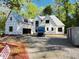 New construction home featuring windows, garage, and gravel driveway amid a wooded lot at 708 Catawba St, Raleigh, NC 27609