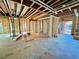 Framed construction of kitchen showcasing exposed beams, flooring, and room layout at 708 Catawba St, Raleigh, NC 27609