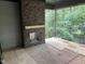 Outdoor patio area with a brick fireplace under construction and a view of the trees at 708 Catawba St, Raleigh, NC 27609