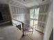 Unfinished staircase with large windows, offering bright and airy views at 708 Catawba St, Raleigh, NC 27609