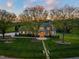 Aerial view of elegant stone home with mature trees and perfectly manicured landscaping at 1641 Legacy Ridge Ln, Wake Forest, NC 27587