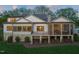 Back of home featuring stone and siding exterior, balcony, and screened-in porch at 1641 Legacy Ridge Ln, Wake Forest, NC 27587
