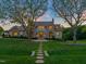 Stunning stone and shingle home boasts mature trees, manicured lawn, and inviting stone walkway at 1641 Legacy Ridge Ln, Wake Forest, NC 27587