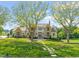 Grand stone and shingle home featuring a lush lawn, mature trees, and a stone walkway at 1641 Legacy Ridge Ln, Wake Forest, NC 27587